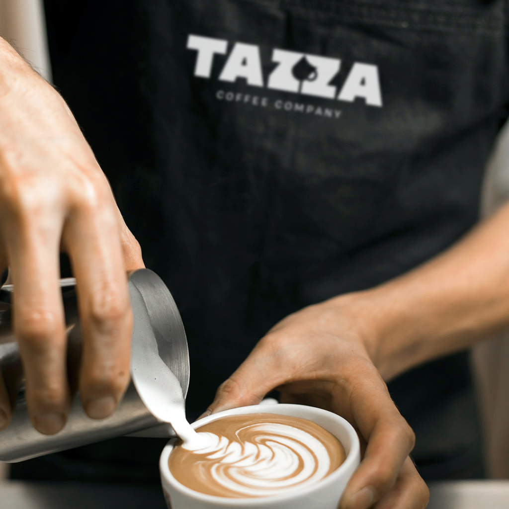 man pouring latte art